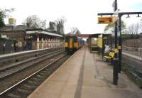 A Liverpool Lime Street to Manchester Victoria service arrives at Roby on 19 April 2014. On the right work is underway to reinstate two platforms.<br><br>[John McIntyre 19/04/2014]