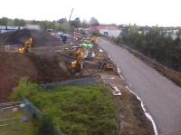 A grab shot looking west towards Bicester Town station, from a train heading for Bicester North in April 2014. The picture shows work on the East-West Rail Link running below the camera, as well as progress on the new West-to-South curve centre left. The latter will allow trains to run direct between Oxford and Marylebone.<br><br>[Ken Strachan /04/2014]