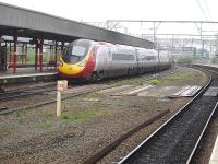 Virgin Pendolino 390001 leaves Stockport on the 10.17 departure to Manchester Piccadilly, having just passed the 183 mile post located in the centre of the station.<br><br>[David Pesterfield 01/05/2014]