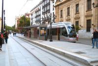 Tram 304 pauses at Seville's Archivo de Indias stop on 1 May 2013.  It has just left the battery operated section of track from Plaza Nueva [see image 47190] and raised its pantograph for the catenary section for the remainder of the route to the San Bernardo terminus. A service travelling in the opposite direction approaches in the distance.<br>
<br><br>[Andrew Wilson 01/05/2013]