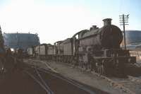 A Castle class 4-6-0 stands at the head of a lineup of condemned ex-GWR locomotives in a siding at Swindon works in the summer of 1964. <br><br>[John Robin 25/08/1964]