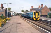 Arriva Trains Wales 158820 calls at Helsby on 28 April 2014 with the 14.50 Manchester Piccadilly - Llandudno. Helsby is a junction and there are two other platforms out of view to the left on the line from Ellesmere Port which joins the Warrington to Chester line beyond the footbridge.<br><br>[John McIntyre 28/04/2014]
