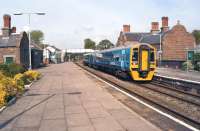 Arriva Trains Wales 158820 calls at Helsby on 28 April 2014 with the 14.50 Manchester Piccadilly - Llandudno. Helsby is a junction and there are two other platforms out of view to the left on the line from Ellesmere Port which joins the Warrington to Chester line beyond the footbridge.<br><br>[John McIntyre 28/04/2014]