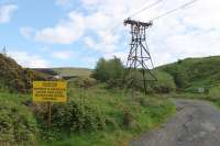 The ropeway from Claughton Moor only crosses two public rights of way. The main A683 road in the village is well protected from falling material by a substantial bridge [See image 46773]. Up on the moor near the clay pit entrance this track requires less sophisticated measures. It would have been nice to include a bucket in this picture but, late on a Friday afternoon, operations had stopped for the weekend. <br><br>[Mark Bartlett 09/05/2014]