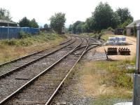 View south from Llandovery Station over the end of the station loop in August 2013. Bagged ballast and a stack of new wooden sleepers with chairs stand alongside the engineers siding accessed off the northbound platform line. [Ref query 9186]<br><br>[David Pesterfield 01/08/2013]