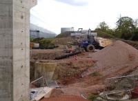 I am glad to say that my 2011 prediction came through [see image 35439]. After a pause due to the recession, work has now resumed on the new railway to terminal #3 at DIRFT, seen here on 9 May 2014. The pier on the left is on the South side of the A428.<br><br>[Ken Strachan 09/05/2014]