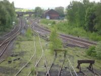 Looking over the east end approach, departure lines and sidings at Healey Mills in May 2014. The former Horbury Bridge goods shed and yard stand on the right, with the site of Horbury & Ossett Station island platform immediately beyond the Bridge Road over-bridge seen ahead. Foliage is gradually covering all non operational and lightly used lines.<br><br>[David Pesterfield 14/05/2014]