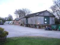 A view of the dry goods store building at the former Masham Station goods yard in April 2014. Next along is the Caravan and Campsite amenity building, which is built on the site of the former engine shed. Beyond this is the in-filled and surfaced over turntable pit below the caravans.<br><br>[David Pesterfield 21/04/2014]