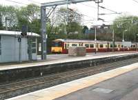 Looking across the through platforms at Airdrie on 8 May 2014 as the terminating 09.23 service from Balloch runs into bay platform 1.<br><br>[John Furnevel 08/05/2014]