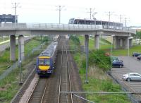 Edinburgh tram 272 and ScotRail 170417 meet west of Edinburgh Park station on 20 May.<br><br>[Bill Roberton 20/05/2014]