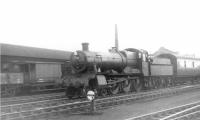 A stopping train leaving Oswestry on the Whitchurch line in August 1960 behind 7822 <I>Foxcote Manor</I>. Photographed from Oswestry shed yard, with the Cambrian Railway works in the background [see image 30900]. [Ref query 9460]<br><br>[David Stewart 08/08/1960]