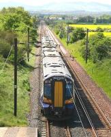 With the Pentland Hills barely visible through the haze, ScotRail 380105 leaves Wallyford on an unusually warm 13 May 2014 forming the 12.27 North Berwick - Edinburgh Waverley.<br><br>[John Furnevel 13/05/2014]