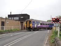 156475 moving out of the turnback sidings on the Blyth line and crossing Coopies Lane at Morpeth on 21 May. Morpeth station is just off picture to the left.<br><br>[Peter Todd 21/05/2014]