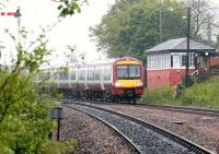 A southbound service about to arrive at Larbert during heavy rain on 25 May 2005 passes Larbert North signal box.<br><br>[John Furnevel 25/05/2005]