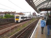 A train on the London - Tilbury - Southend line passing Shadwell DLR station on 26 May.<br><br>[John Thorn 26/05/2014]