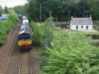 DRS 66432 crosses the Forth and Clyde Canal between Falkirk Grahamston and Camelon with the 4A13 Grangemouth - Aberdeen intermodal on 30 May.  Swing Bridge East signalbox was located next to the house on the far left of the picture. The house on the right is the former lock keeper's cottage [see image 20786]. <br><br>[Bill Roberton 30/05/2014]