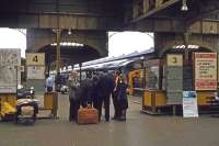 In the days before dedicated customer care, anxious passengers accost BR staff on the concourse at Norwich on 22nd July 1978. Train information used to be conveyed via an unreliable combination of chalked notices, randomly sited posters, small print departure boards (some near floor level), frequently incorrect DMU blinds and a garbled tannoy, so it was always advisable to ask anyone who looked 'official'. The four rail routes from Norwich radiated out north, east, south and west, so before the advent of on-train, and later mobile phones, a mistake could prove very stressful, both for the passenger and anyone waiting for them at their destination.<br><br>[Mark Dufton 22/07/1978]