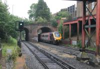 Pokesdown, a suburb of Bournemouth, has a basic service of two trains per hour in each direction but many more go through without stopping. Cross Country Voyager 220015 passes through the twin arch bridge at the east end of the station on the last leg of a Manchester to Bournemouth service. <br><br>[Mark Bartlett 23/05/2014]