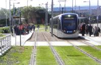 Crowds eagerly waiting to board trams at Gyle Centre around 10.30am on Saturday 31 May 2014, the first day of public services. <br><br>[Alasdair Taylor 31/05/2014]