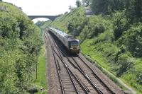 Loooking west at Uphill Junction, towards Brunel's magnificent bridge spanning the cutting on 18 May, as 43304 leads a CrossCountry HST on a Newquay to Edinburgh service. The crossover in the foreground is used by westbound trains from the Weston-Super-Mare loop to regain the Down Main line. [See image 26183] <br><br>[Mark Bartlett 18/05/2014]