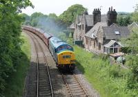 Back on the main line after an extensive overhaul is EE Class 40 40145. Scheduled to haul its first excursion on 7th June 2014 (Rawtenstall to Oxford) it was sent to Carnforth the day before to collect the stock and a number of enthusiasts paid to travel back to Bury on a circuitous route behind the gleaming veteran, seen here passing the closed station at Borwick just after leaving Carnforth. <br><br>[Mark Bartlett 06/06/2014]