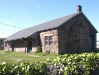 The old goods shed at Wooler on 22 May 2004. View is north east from alongside the A697 with the station building beyond [see image 2319]. [Ref query 10024]<br><br>[John Furnevel 22/05/2004]