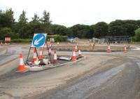 The new 4-way roundabout at Tweedbank looking north east on 9 June 2014. Running across the picture left to right is Tweedbank Drive, linking Tweedbank with the A6091 Melrose roundabout, while straight ahead is the entrance to what will become Tweedbank station and car park. [See image 13769] <br><br>[John Furnevel 09/06/2014]