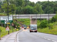 The approach to Hardengreen Roundabout from the south west on the B6392 on 13 June 2014, with the new Borders Railway bridge dominating the scene. <br><br>[John Furnevel 13/06/2014]