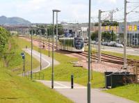 A city bound tram runs parallel with Bankhead Drive on 12 June 2014, shortly after leaving Edinburgh Park station on its way to York Place.<br><br>[John Furnevel 16/06/2014]