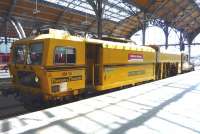 A DB Bahnbau Gruppe tamper standing alongside the platform at Lubeck on 31 May 2014.<br><br>[John Steven 31/05/2014]