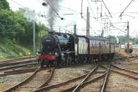 With 86259 waiting in the sidings, Stanier 8F no. 48151 takes the <I>Cumbrian Coast Express</I> out onto the main line to Carlisle following the loco swap at Carnforth on 14 June 2014.<br><br>[John McIntyre 14/06/2014]