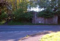 Coldstream station was actually located across the border in the nearby village of Cornhill-on-Tweed. This view is south across the A697 from the station approach road, which now leads only to housing. The sloping pathway on the left leads to the site of Cornhill Junction [see image 47594], and a choice of two trackbed footpaths.<br><br>[Ken Strachan 21/05/2014]