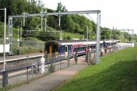 The 11.22 service to Glasgow Central High level under the newly installed OHLE wiring at Carmyle on 19th June 2014.<br><br>[Colin McDonald 19/06/2014]