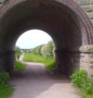 Looking north west along the closed line to Southport Lord Street from the site of Altcar and Hillhouse station (closed 1952) through the bridge carrying the B5195 over the trackbed. [Ref query 6400]<br><br>[Ken Strachan 16/05/2014]