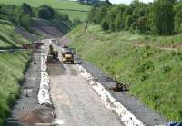 The climb south from the site of Tynehead station on 19 June 2014 heading for Falahill summit. The link to the former goods yard, now used as an access point for construction traffic, is on the left of the picture.<br><br>[John Furnevel 19/06/2014]