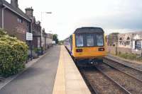 Class 142s have appeared on Cumbrian Coast services joining Classes 153s and 156s. My ride from Askam to Ravenglass was lively in places as 142005 bounced along. The unit stands at Ravenglass whilst working a Barrow-in-Furness to Carlisle service on 14 June 2014.<br><br>[John McIntyre 14/06/2014]