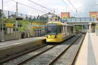 The long straight sections of the East Didsbury Metrolink line have something of a main line feel about them but, waiting for a tram at the new stop at Firswood, it is still hard to imagine the <I>Scots</I> and <I>Jubilees</I> that once hauled Midland expresses through here. 3056 calls on a service heading for Rochdale via Manchester.  <br><br>[Mark Bartlett 09/06/2014]