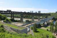 Old and new in Edmonton, Canada as Streetcar 33 heads south over the High Level Bridge to Strathcona. Below, a modern LRT train also heads south towards Century Park over the Dudley B Menzies Bridge. The preserved streetcar is operated by the Edmonton Radial Railway Society who run a seven days per week service over the High Level Bridge in the summer months. The lower deck of this old structure is still open to traffic and pedestrians. <br><br>[Malcolm Chattwood 07/06/2014]