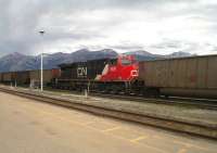 Canadian National GE ES44AC diesel 2850 provides distributed power in the middle of a heavy westbound coal train passing through Jasper, Western Alberta, in June 2014. Gradients around Jasper can be as steep as 1:40 and the clever technology that allows distributed power greatly assists the efficient movement of freight through the mountains.<br><br>[Malcolm Chattwood 12/06/2014]