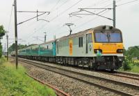 The <I>Retro Electric Scot</I> ran to Edinburgh on 28th June 2014 hauled by 92041 <I>Vaughan Williams</I>. The tour started at Stockport behind a Class 66 and reached Preston via Huddersfield and Copy Pit. The northbound Class 92, with a mixed bag of coaching stock, is seen passing Brock running around 25 minutes late.<br><br>[Mark Bartlett 28/06/2014]