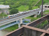 From preserved Streetcar 33, passing over the High Level Bridge in Edmonton, this is the view down to the modern Dudley B Menzies Bridge. A train comprising four articulated LRT SD160 sets heading south can be seen, as can the foot passenger walkway, slung underneath the rail bridge. <br><br>[Malcolm Chattwood 16/06/2014]