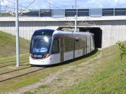Tram 268 emerges from under the A8 Glasgow Road on the the approach to Gyle Centre on 1 July.<br><br>[Bill Roberton 01/07/2014]