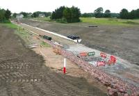 The new Borders Railway route through Shawfair on 27 June 2014. View is north east, with Shawfair station under construction just off picture in the left background.<br><br>[John Furnevel 27/06/2014]