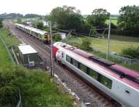 In the passing. London Midland and Virgin services pass at Gayton near Blisworth, Northants, in June 2014.<br><br>[John Steven 24/06/2014]