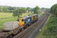 Whistling northwards through the Wyre countryside, two veteran Class 20s take flasks from Crewe to Sellafield on 2nd July 2014. 20304+20312 have just passed the footbridge at Broad Fall Farm in Scorton. <br><br>[Mark Bartlett 02/07/2014]