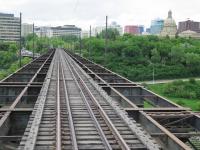 I was grateful to the crew of preserved Streetcar 33 when they stopped to allow me to take this picture, looking across the Edmonton High Level Bridge, from the rear cab. Public tramcar services operated until 1951 but when rails were relaid in 1979 only a single track was put in place where once there were three. Just like its Tyneside namesake, pedestrians and traffic use the lower deck of the bridge below the tramway. <br><br>[Malcolm Chattwood 16/06/2014]