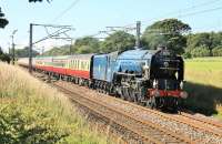 An early fifties re-creation as blue liveried A1 60163 <I>Tornado</I> takes a full rake of <I>Blood and Custard</I> stock south along the WCML at Woodacre on 5th July 2014. The Pacific had hauled the <I>Border Raider</I> from Crewe to Carlisle earlier in the day and was now retracing its route on a fine summer evening. <br><br>[Mark Bartlett 05/07/2014]