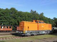 Contrast at Putbus on 17th June - a standard-gauge diesel working for the Pressnitztalbahn company rests in Putbus station yard, while narrow-gauge stock of the Ruegensche Baederbahn  (featuring delightful open platforms at each end of the coaches) stands in the background.<br><br>[David Spaven 17/06/2014]