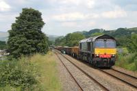 With no more than a quiet hum from the engine, DRS 66426 lifts a heavy Carlisle to Crewe infrastructure train up the 1:82 climb out of the Ribble Valley through Langho station. Although the box wagons at the front appear empty they were actually loaded with concrete sleepers.    <br><br>[Mark Bartlett 01/07/2014]