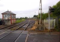 Bardon Hill box (one of at least two mechanical boxes still working in the Coalville area) on the west side of Grange Road level crossing on a wet July day in 2014. The Freightliner 66 in the siding in the background is waiting to pick up loaded stone wagons for onward transit.<br><br>[Ken Strachan 04/07/2014]